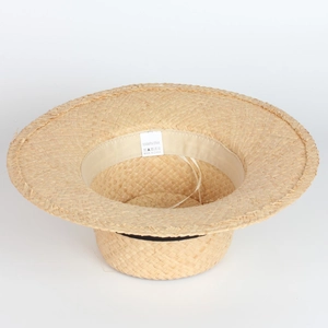 Detailed macro view of 100% raffia straw texture with sweatband and interior wash label