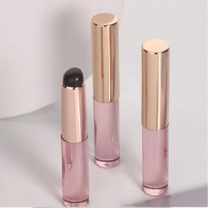 Detail of round silicone lip brush with rose gold cap and black applicator tip