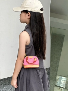 Mini pink vintage shell crossbody bag for girls with brown trim and gold hardware strap