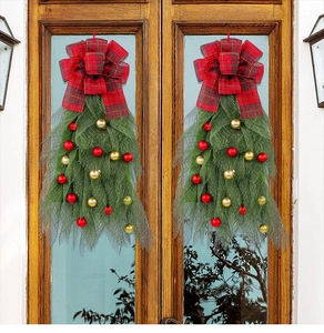 Close-up of festive Christmas wreath with red plaid bows and gold baubles on wooden doors