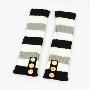 Detail of striped knitted leg warmers featuring decorative wooden buttons and soft wool texture