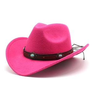 Detail of hot pink felt cowboy hat featuring leather band with turquoise studs