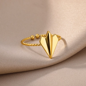 Detailed macro shot of 18k gold butterfly ring with twist band on silk fabric