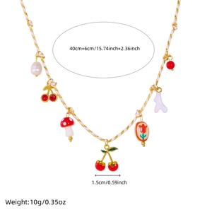 Pastoral gold plated necklace with ceramic flower and cherry charms on a woven cord