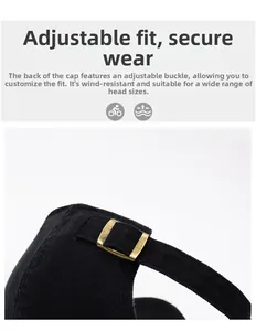 Detail of adjustable bronze metal buckle on a black washed cotton baseball cap