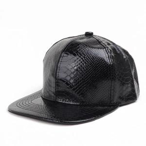Close-up of black faux leather snapback hat with embossed crocodile texture and glossy finish
