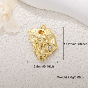 Detail view of gold-plated cameo pendant with embossed female bust and crystal stone