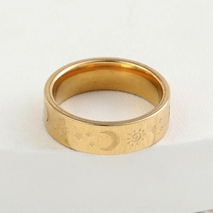 Brushed gold stainless steel ring engraved with celestial sun, moon, and star patterns