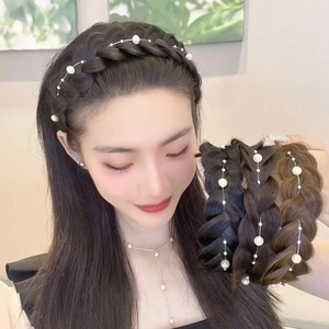 Macro view of woven fishbone braid headband with white pearl accents in various hair colors