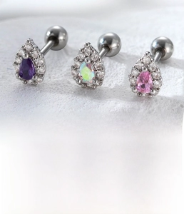 Detailed view of silver titanium steel cartilage studs with colorful teardrop zircons
