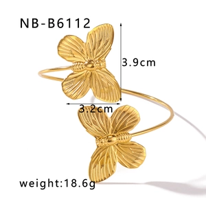 Detail view of gold butterfly open cuff with dimensions 3.9cm by 3.2cm and 18.6g weight
