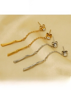 Detail of titanium steel tassel earrings with sparkling rhinestones in gold and silver