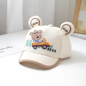 Close-up of baby baseball cap with 3D bear ears and soft rubber racing bear patch