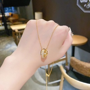 Detail of gold luxury necklace featuring interlocking rings with shimmering crystals