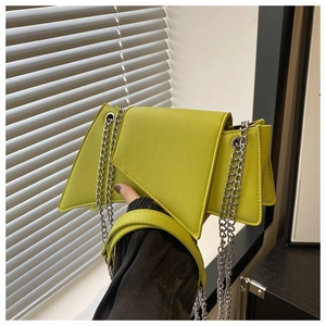 Detailed view of neon green geometric underarm bag with silver chain and leather handle