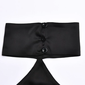 Detail of black satin halter top featuring three buttons and unique back cutout design