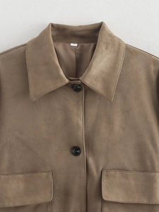 Detail of brown faux suede jacket featuring point collar and black buttons
