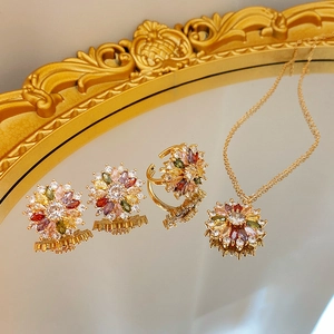 Macro view of gold flower necklace and earrings set with colorful zircon crystals