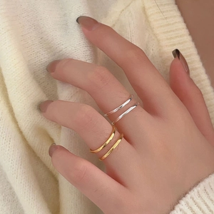 Minimalist 925 sterling silver stacked rings in gold and silver finish on finger