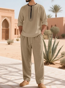 Detail of men's linen beach set featuring a buttoned collar and drawstring waistband