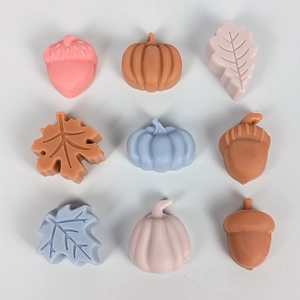 Detailed grid of pumpkin, leaf, and acorn shaped silicone crafts in pastel colors