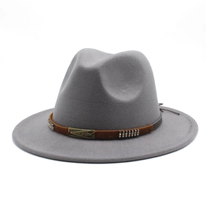 Detail of grey wool fedora hat featuring a brown woven band and bronze metallic G plate