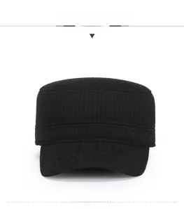 Close-up of black wool flat top military cap with textured vertical knit and metal badge