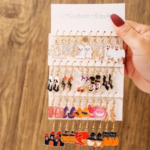 Detail of Halloween earring set with ghost, pumpkin and bat charms on display card