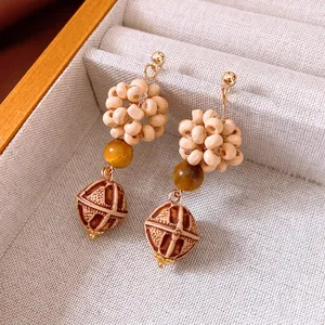 Bohemian style beaded drop earrings with wooden beads and tribal geometric patterns