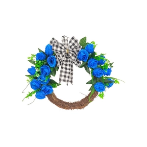Detail of blue roses and black and white plaid bow on rustic woven rattan wreath