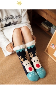 Cozy winter socks featuring reindeer patterns and plush fleece lining in home setting