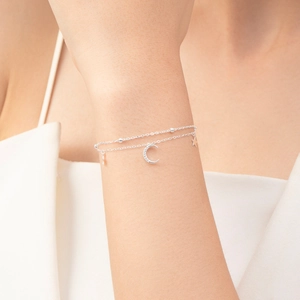 Elegant s925 silver double-layered bracelet featuring moon and star pendants on wrist