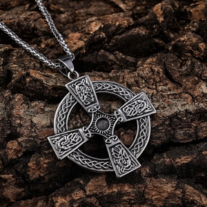 Vintage Celtic cross pendant necklace in silver finish on natural tree bark background