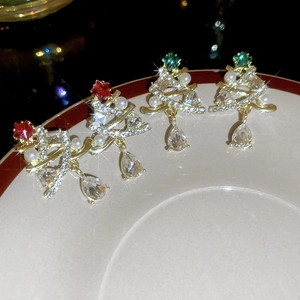 Sparkling Christmas tree earrings with pearls and crystals shown on a white jewelry plate