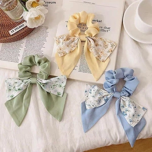 Set of three floral bow scrunchies in yellow, light blue and green colors for women