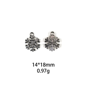 Silver snowflake charms with rhinestones and radial texture measuring 14x18mm