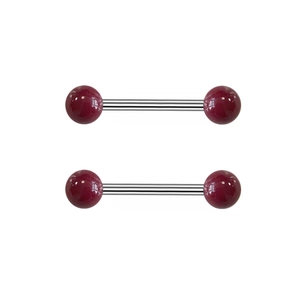 Detail view of two dark red ball nipple rings with silver surgical steel straight bars