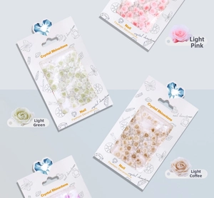 Detailed view of 3D resin roses and pearls nail art kit in assorted pastel colors