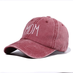 Washed red cotton baseball cap with white MOM embroidery for women in a side view