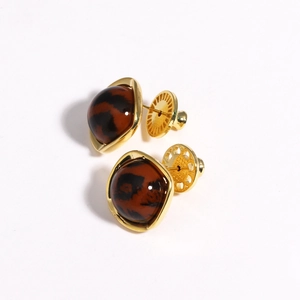 Detail of gold-plated earring lifters with brown stone inlays and support discs
