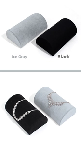Detail of semi-circular velvet jewelry pillows in ice gray and black for bracelet display