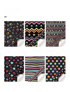 Detail view showing six patterns of black gift wrapping paper with colorful stripes and dots