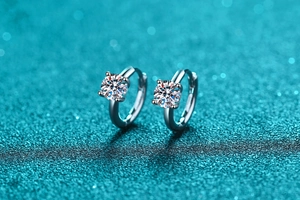 Macro shot of 925 silver hoop earrings with brilliant four-prong moissanite stones