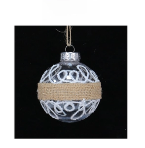 Detail of Christmas ornament ball with brown linen ribbon and white glitter patterns