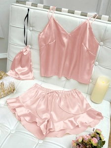 Pink satin camisole and shorts sleepwear set with a drawstring storage pouch