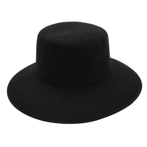 Close-up of the smooth black felt texture and flat wide brim on the minimalist fedora hat