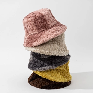 Vertical stack of five plush winter bucket hats in pink, beige, grey, yellow, and brown