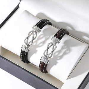Black and brown braided leather bracelets with interlocking silver magnetic clasps in a gift box
