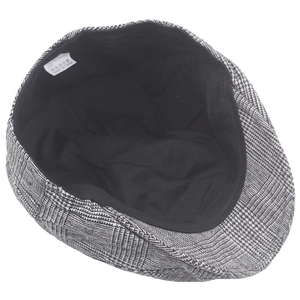 Detailed internal view of vintage plaid newsboy cap with classic black and white pattern