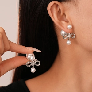 Dual-wear bow pearl stud earrings with sparkling crystals and silver plated finish